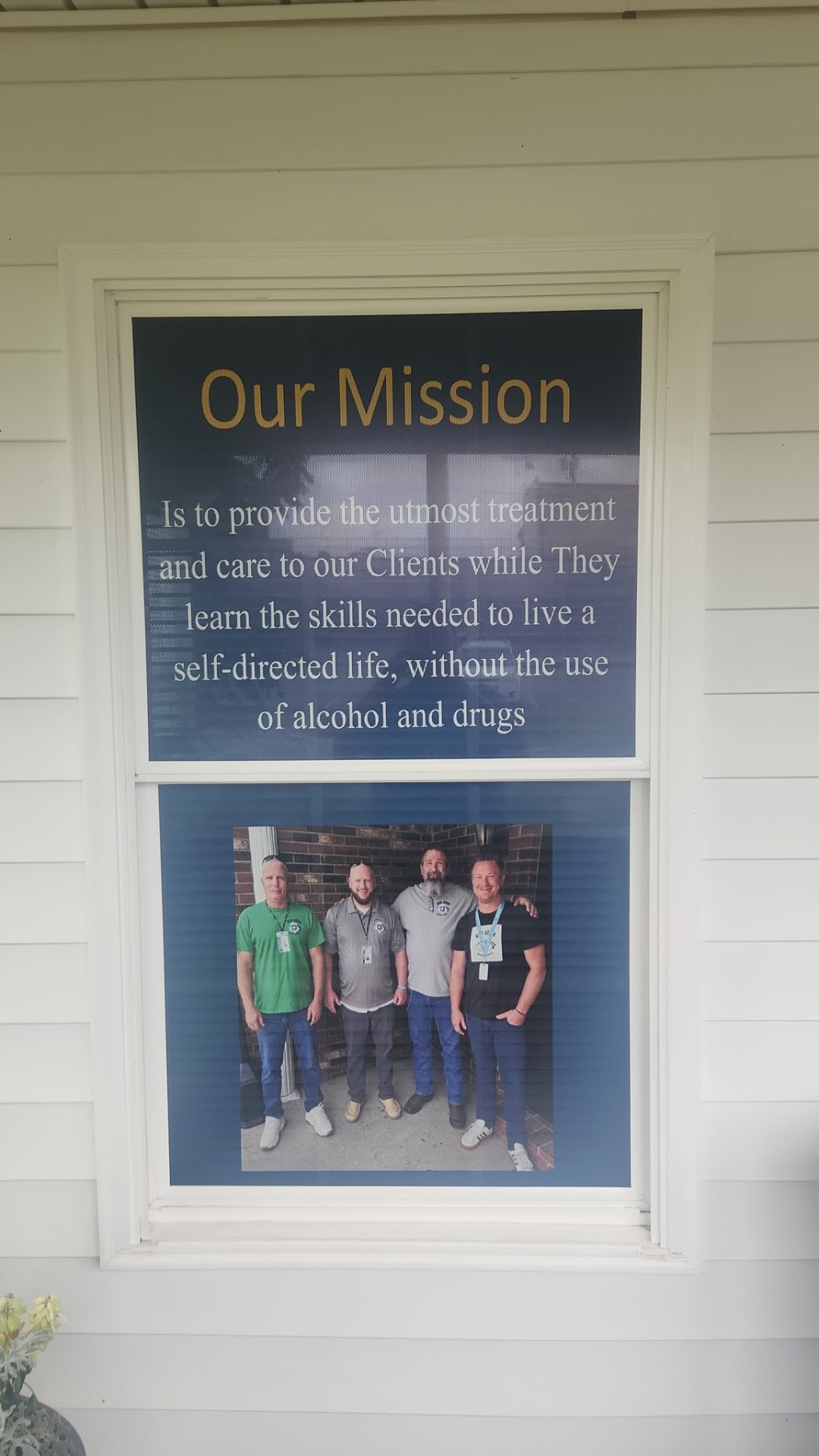 Our Mission sign at New Vision Recovery Center with staff photo
